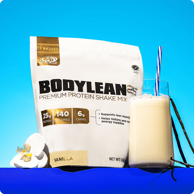BodyLean25&reg; Vanilla Gusset Bag sitting on a blue background next to a mixed vanilla protein shake and a vanilla flower.