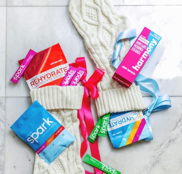 Two white stockings each with AdvoCare products inside of it