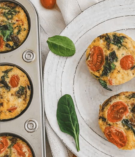 Frittata muffins on a baking tray and a plate